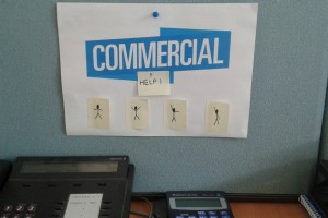 a sign saying 'commercial' with post-it notes reading 'Help' underneath