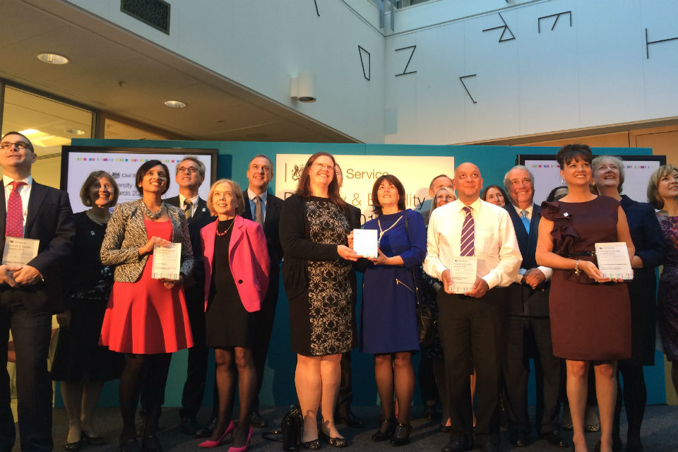 The winners of the Diversity and Equality Awards 2014 standing on stage with their awards.