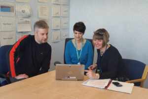 Linda discussing the self assessment tool with her team