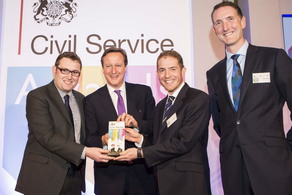 The Prime Minister presenting the Supporting Enterprise & Growth Award  to DECC's Wood Review Report Team at the Civil Service Awards 2014