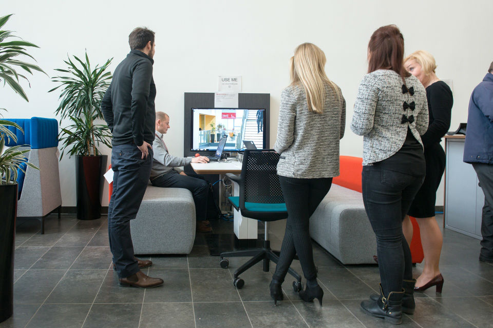 Photo of Dstl staff working in an open plan, hot-desk environment