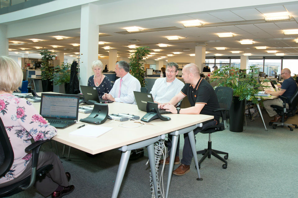 Photo of Dstl staff working in paper-free office