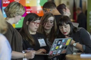 Staff working collaboratively around a laptop at Civil Service Live 2015: Edinburgh