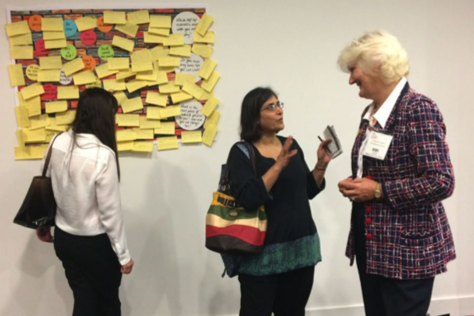 Felicity Harvey, right, speaking to a delegate at CS Live, with another perusing notes on a board back left.