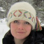 Head shot of Belinda Volans in snowscape wearing woolly hat