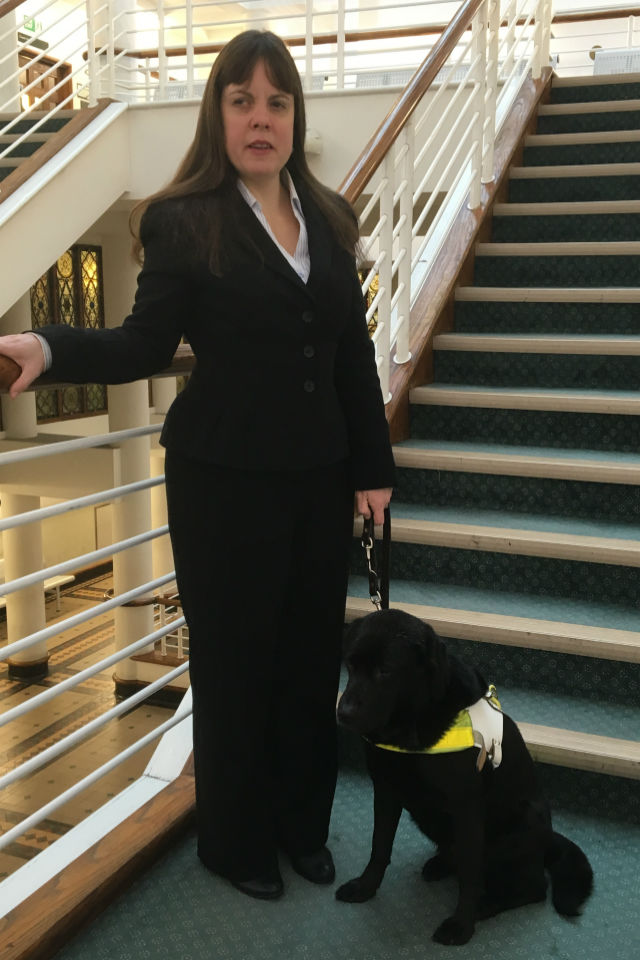 Lisa Boocock with guide dog Bess at her feet