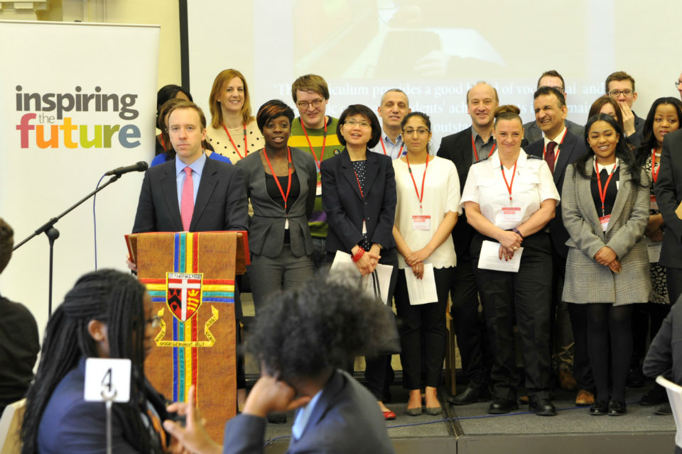 Matt Hancock at lectern with group behind