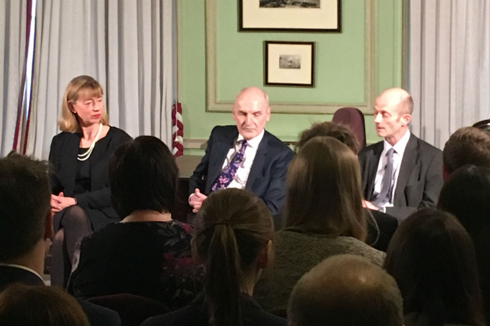 Three permanent secretaries seated in front of audience.