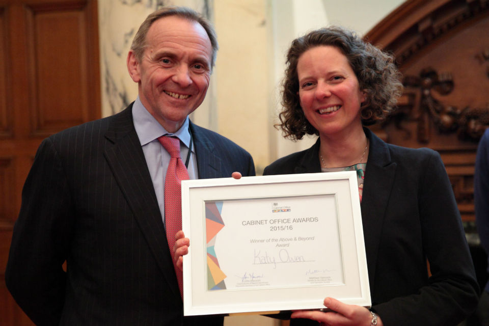 John Manzoni left and Katy Owen with framed award