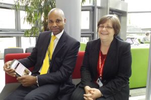 Man and woman on red and grey bench