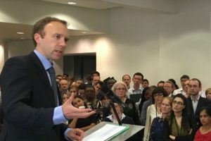 Man at lectern speaking to group