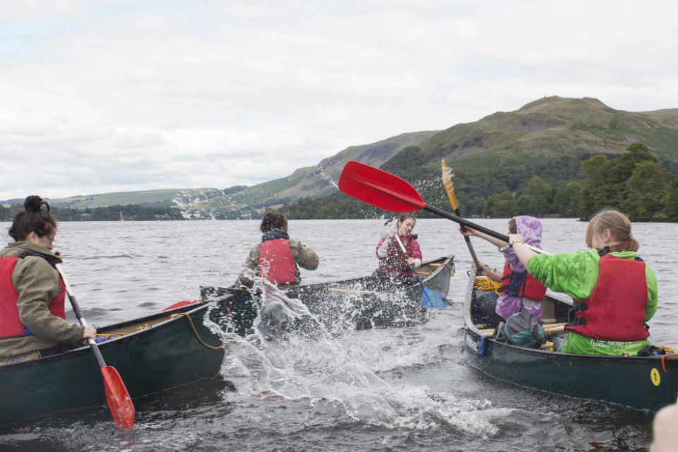 Teenagers in boats on a lake