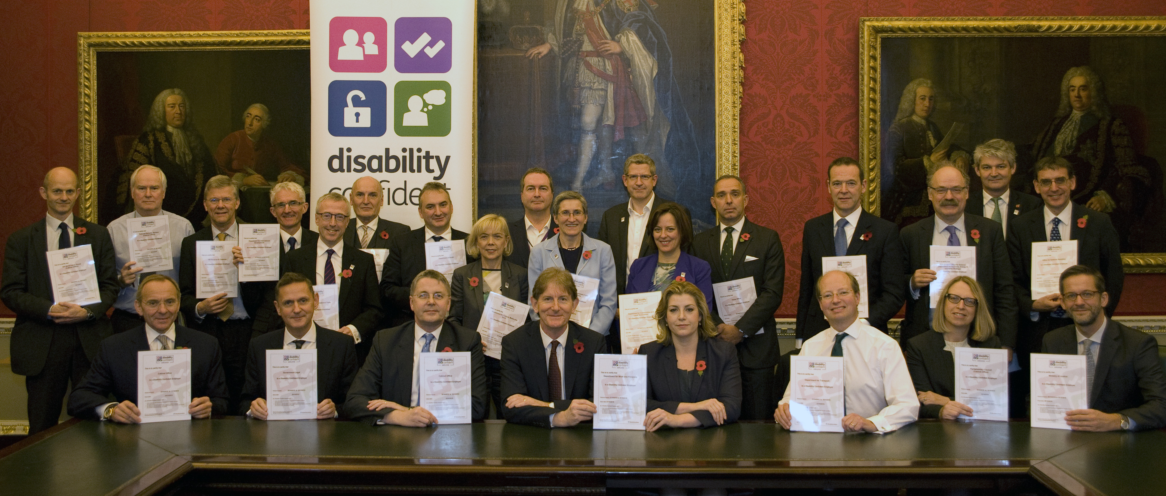 Penny Mordaunt, Minister of State for Disabled People (seated centre right) with Civil Service Permanent Secretaries, committing their departments to be Disability Confident