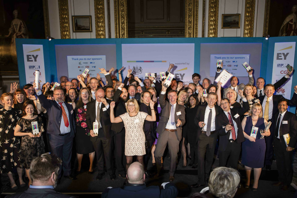 Group of people on a stage celebrating