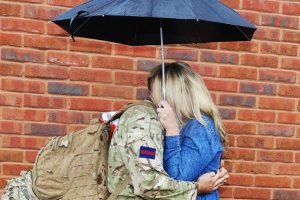 Soldier and partner under umbrella