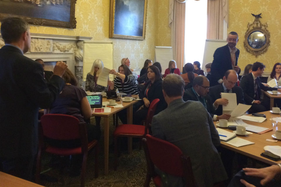 Men and women in discussion groups at tables