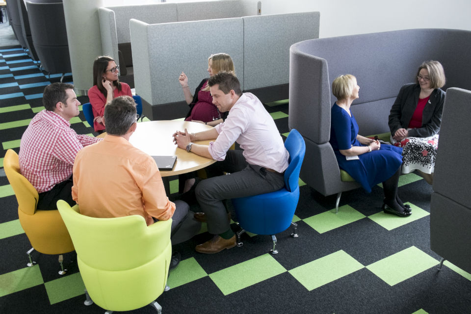 Men and women in office meetings chairs