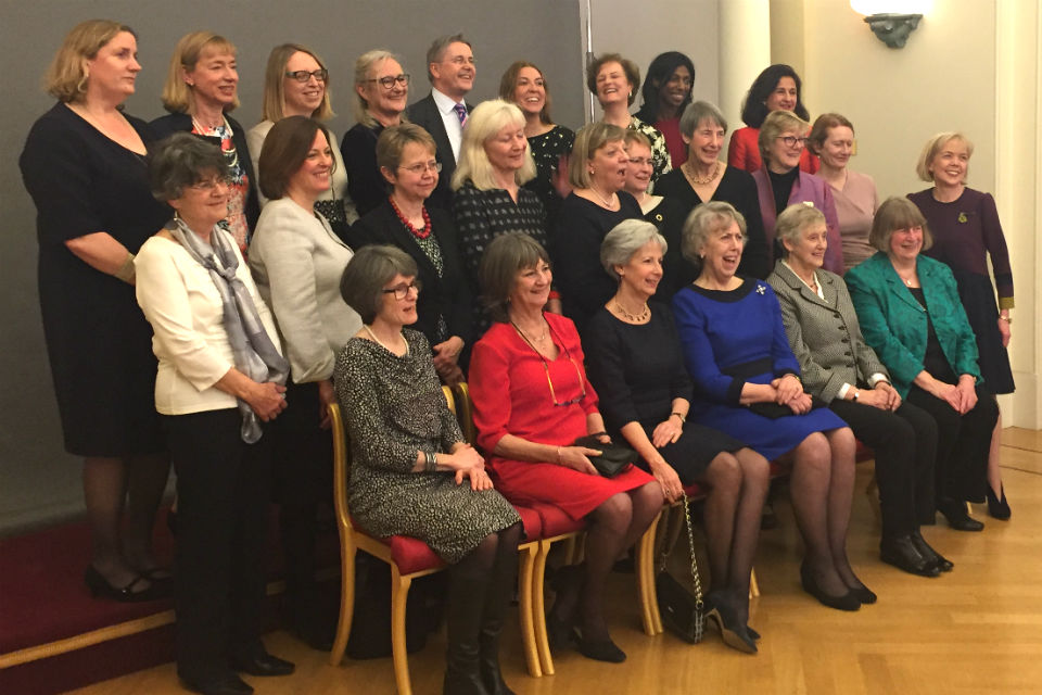 24 women and one man posing for group photo