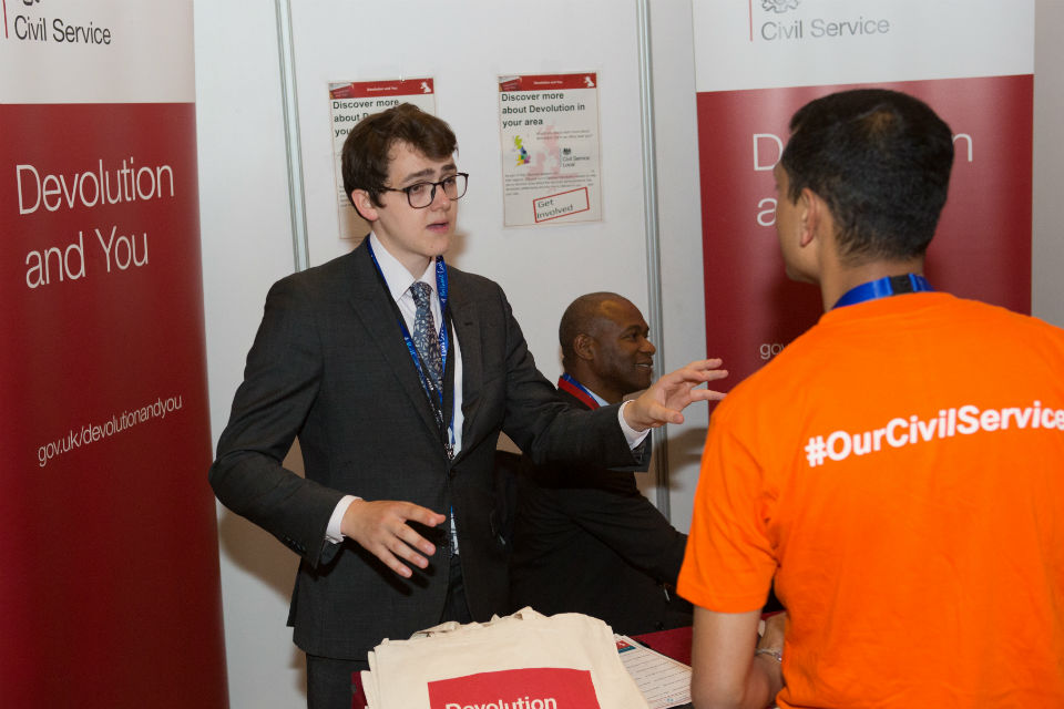 Man talking to another man at an exhibition stand