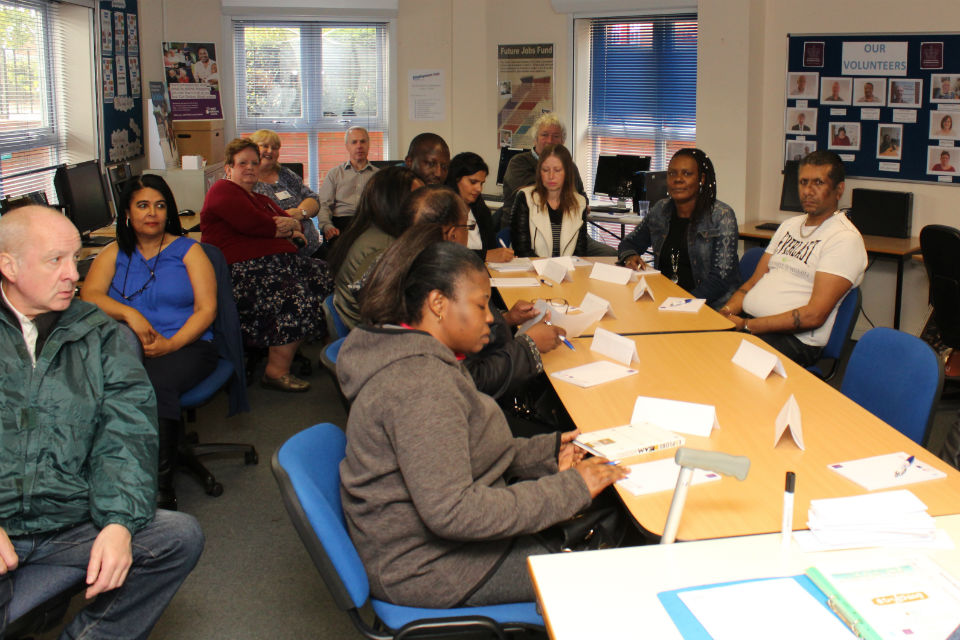 Training session with group around desks and tables