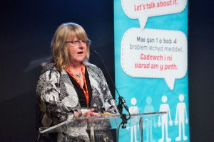 Woman presenting at lectern