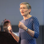 Woman speaking from lectern