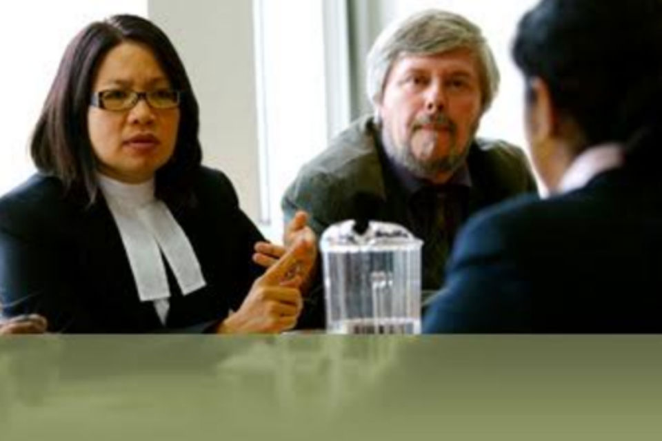 Lawyer in discussion with two others at table