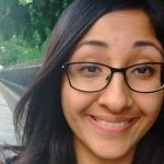 Head shot of bespectacled woman