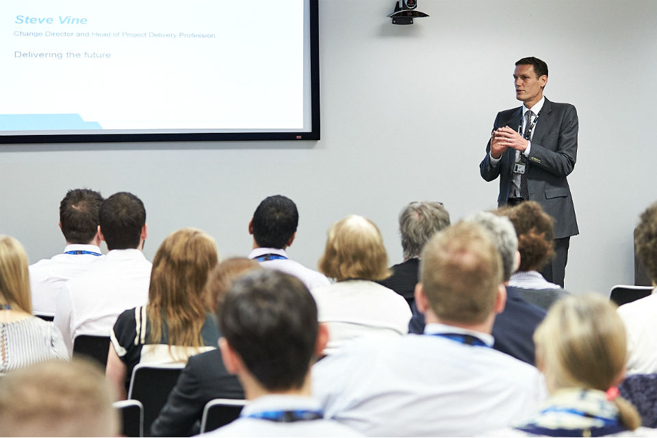 Man speaking to audience at conference