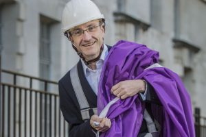 Man in hard hat with purple flag