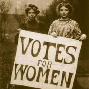 Sepia photograph of two suffragettes with banner