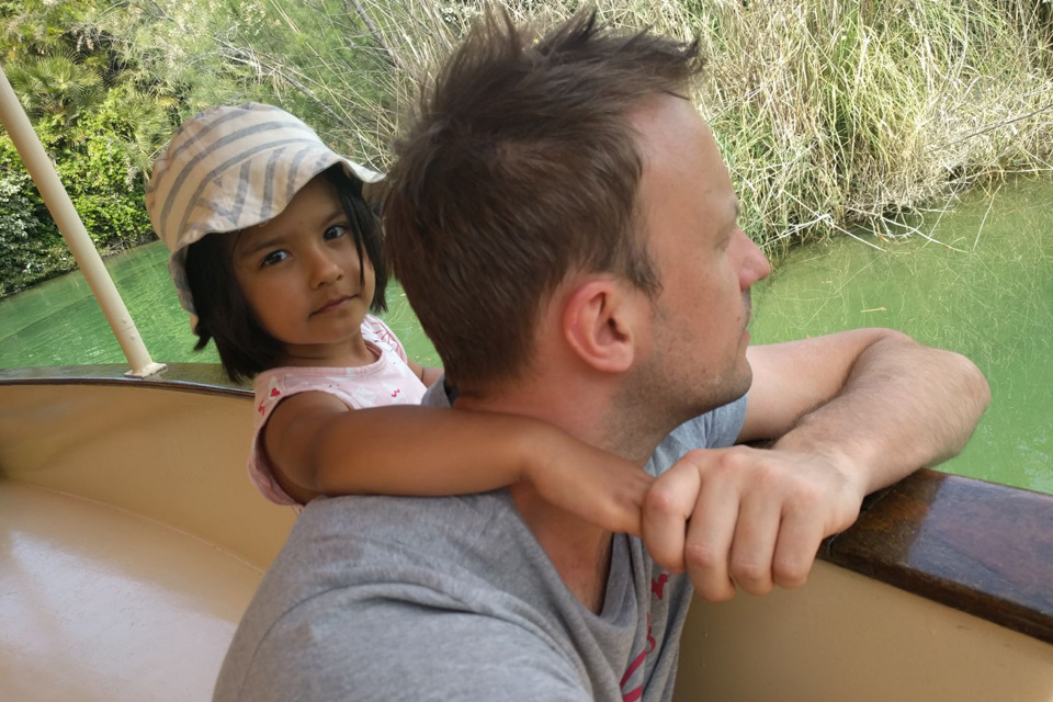 Father and young daughter on river boat