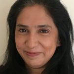 Head shot of woman with long dark hair.