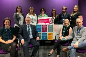 Mental health charity members with posters