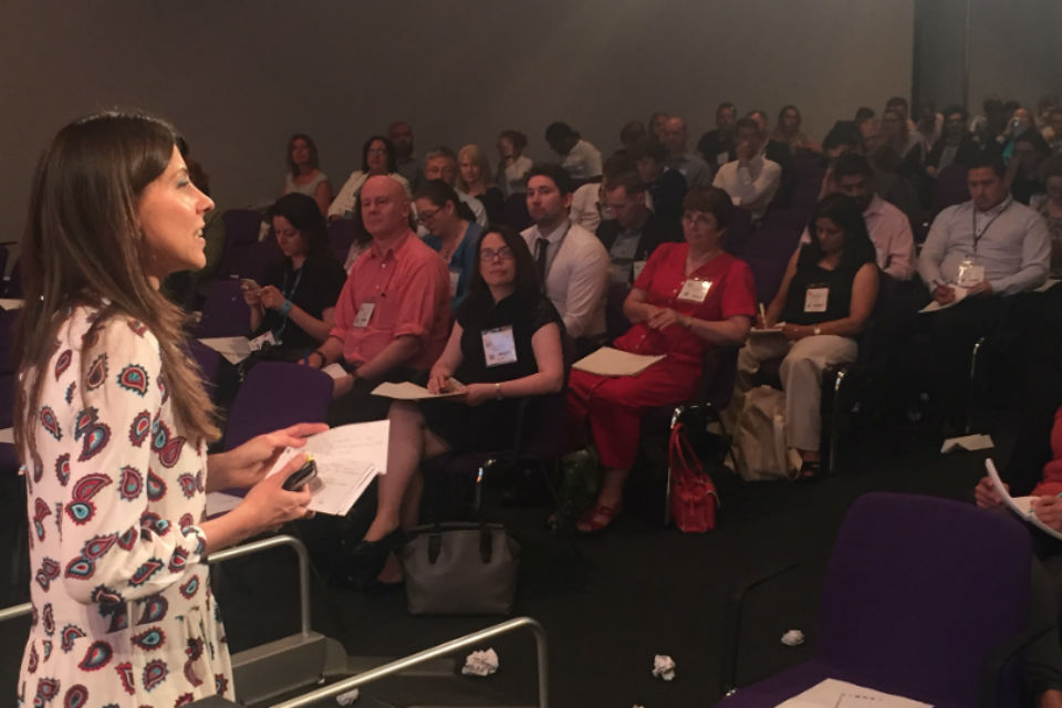 Woman making presentation to seated audience