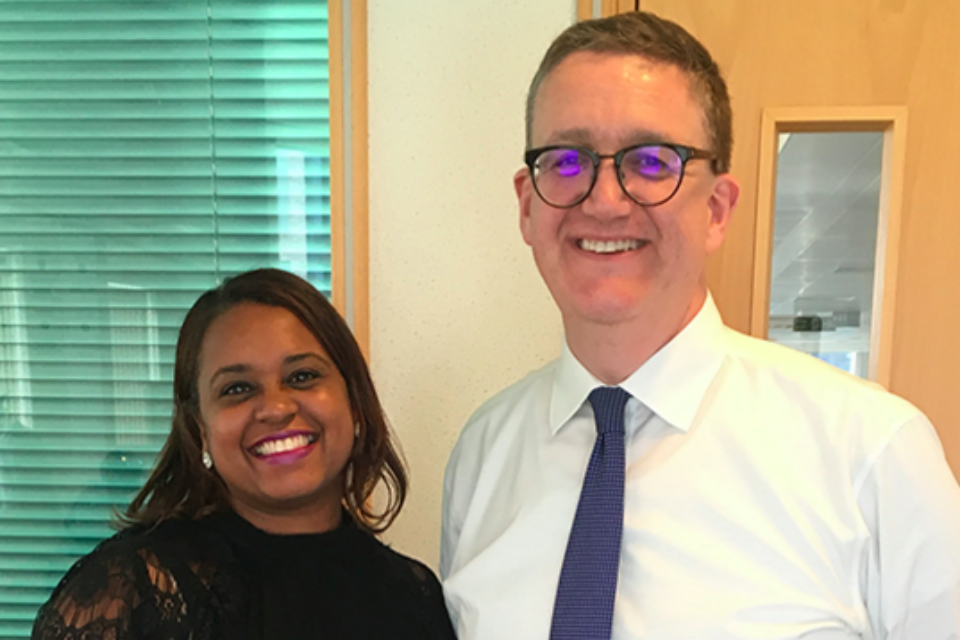 Shakira Keddo and Rupert McNeil standing side by side, smiling at the camera.