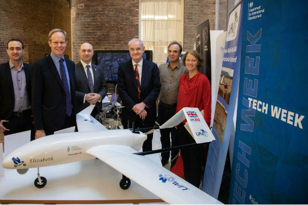 Dr Gavin Smith, Matthew Rycroft CBE, Daniel Ronen, Dr Joseph Barnard, Alex Caccia, and Professor Charlotte Watts beside a prototype of an aid-delivering drone at DFID Whitehall Occasion: Unmanned Aerial Vehicles (UAVs) display for staff. Three British UAV innovators and a British data analysis unit showed staff their technology and pilot projects with DFID.