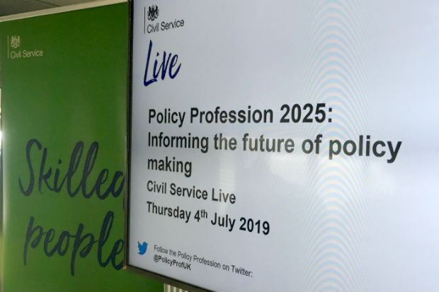 View of a display screen on the stand of the Civil Service Policy Profession at Civil Service Live, showing the text: Policy Profession 2025: Informing the future of policy making, Civil Service Live, Thursday, 4th July 2019