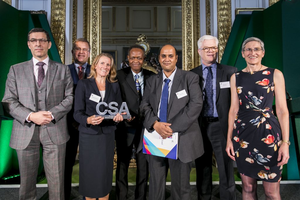 The HM Passport Office winners of the Digital Award, with award presenter Bernadette Kelly, Permanent Secretary for the Department for Transport