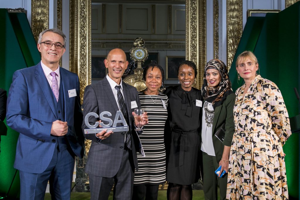 The HMRC winners of the Diversity & Inclusion Award, with award presenter Sarah Healey, Permanent Secretary for the Department for Digital, Culture, Media and Sport