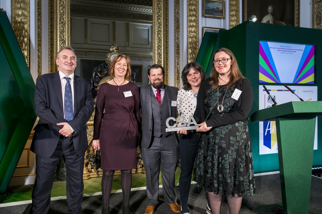 The Scottish Government winners of the Policy & Use of Evidence Award, with award presenter Sir Chris Wormald, Permanent Secretary, Department of Health & Social Care