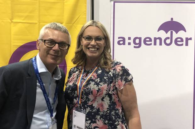 Jonathan Slater with Emma Dunn, Chair of a:gender, alongside a banner displaying the a:gender logo