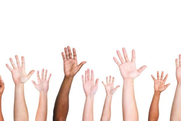 Image of raised hands and arms belonging to a diverse group of people