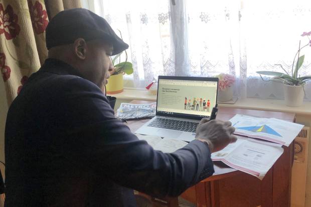 Brian Stanislas at his desk, working from home