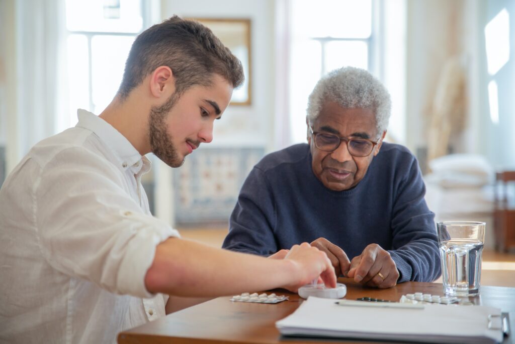 A younger man assisting a pensioner