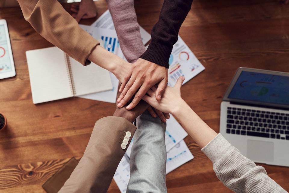 Image showing everyone placing their hands together