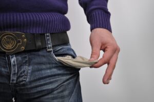 Image of a man emptying out his pocket to suggest lack of money