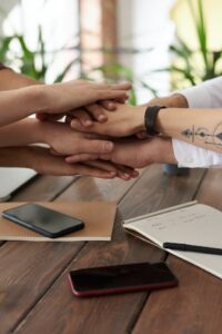 image of diversity at work with colleagues clasping hands