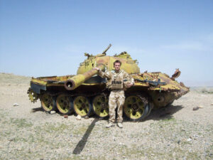 Sam next to destroyed Russian T-55 Tank near the Kajaki Dam