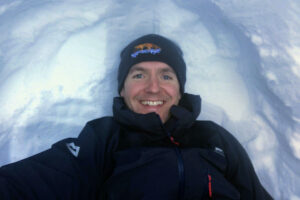 Sam Tillotson in a snow hole learning to survive an avalanche